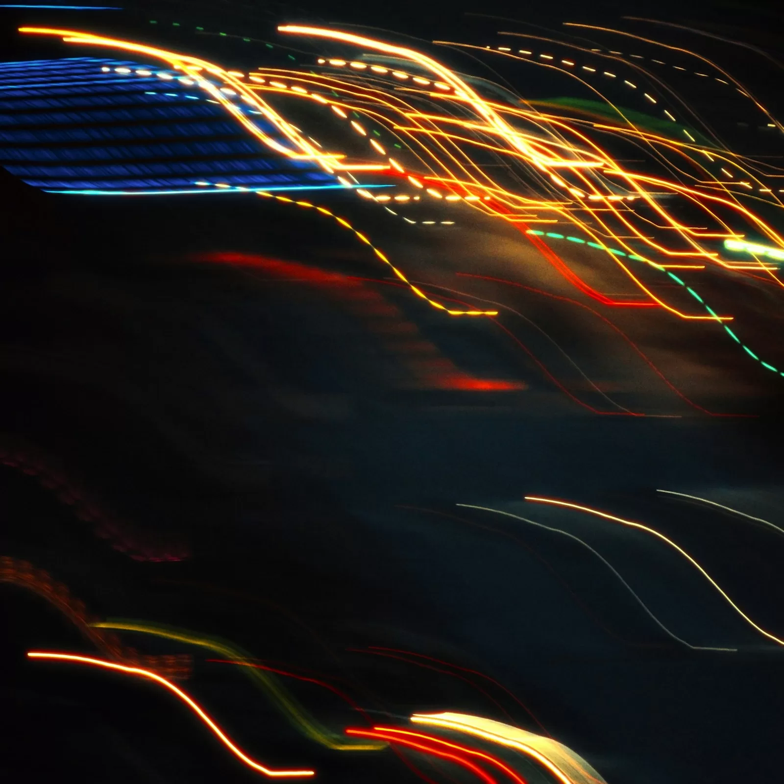 Abstract light trails streaking against a dark background